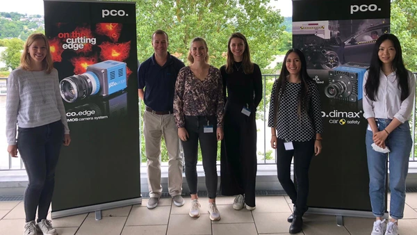 Students standing in front of PCO AG roll-up