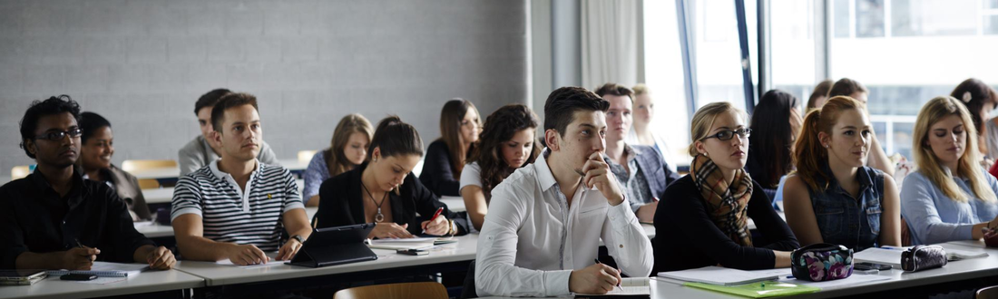 Students sit in three rows in a lecture