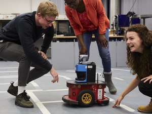 Students with driving roboter