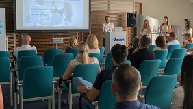 Students give a presentation in front of an audience